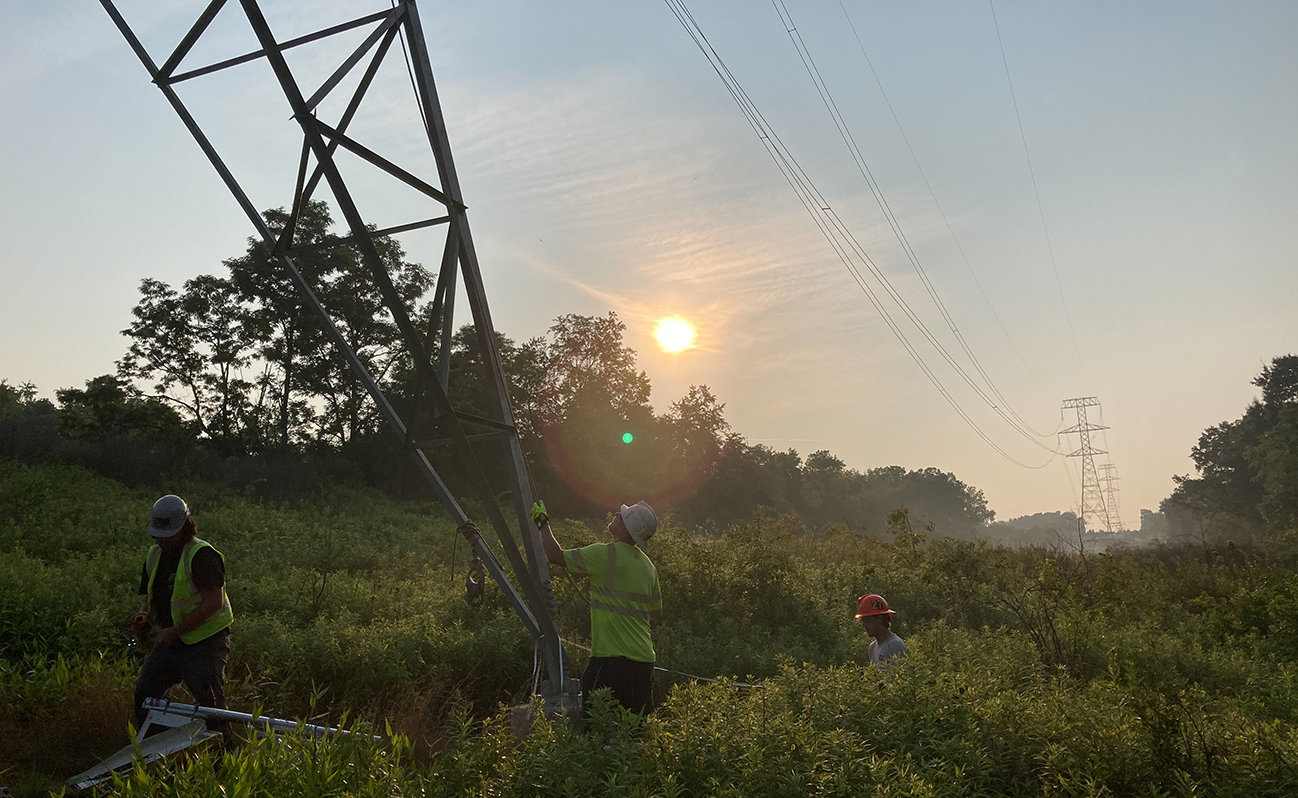 Lineworkers working on transmission facility