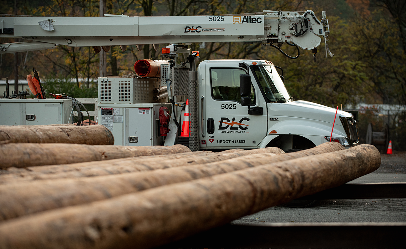 DLC truck and telephone poles on the ground