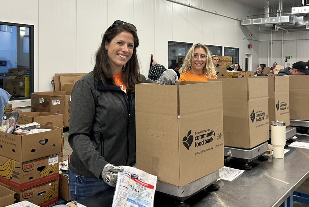 Volunteers packaging boxes at food bank